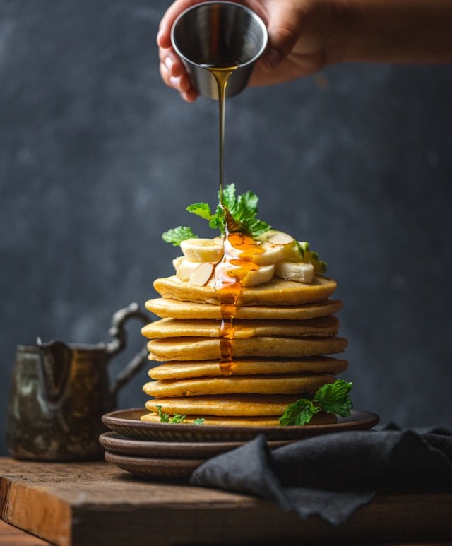 Drizzling honey over perfect pancakes